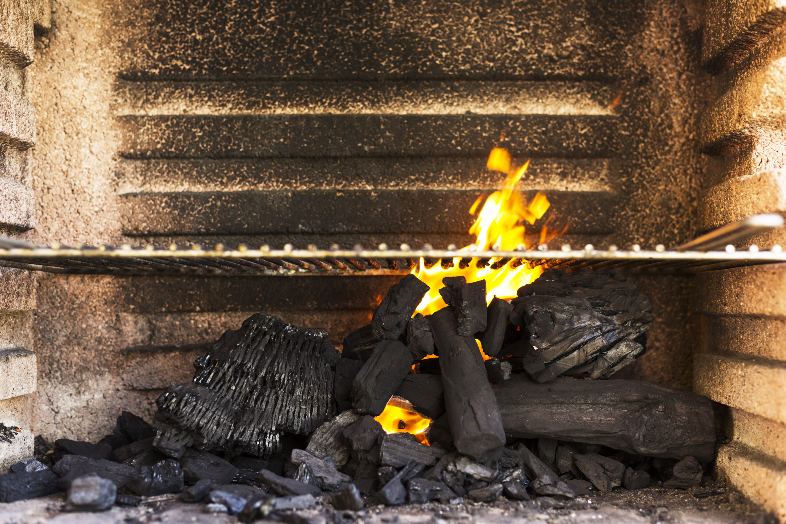 empty-bbq-grill-pit-with-hot-charcoal-briquettes
